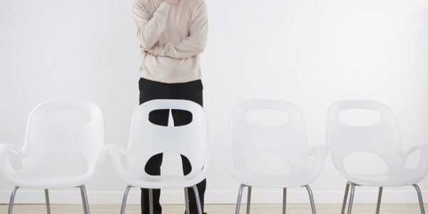 Thinking Businessman Staring at Empty Chairs Thinking Businessman Staring at Empty Chairs