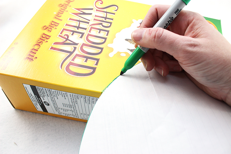 Trace a curved shape onto your cereal box, and cut.