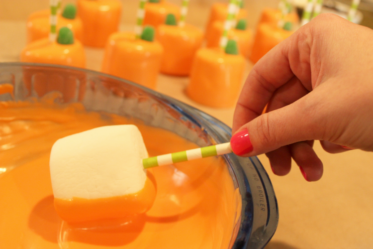 Dip marshmallows in melted orange candy.