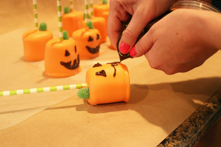 Pipe Chocolate Jack-O-Lantern Faces On Marshmallow Pops