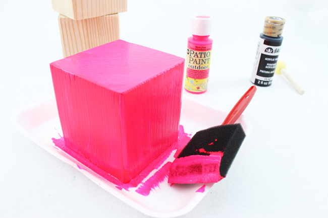 Use a foam brush to paint your wood blocks, making sure to cover them completely.