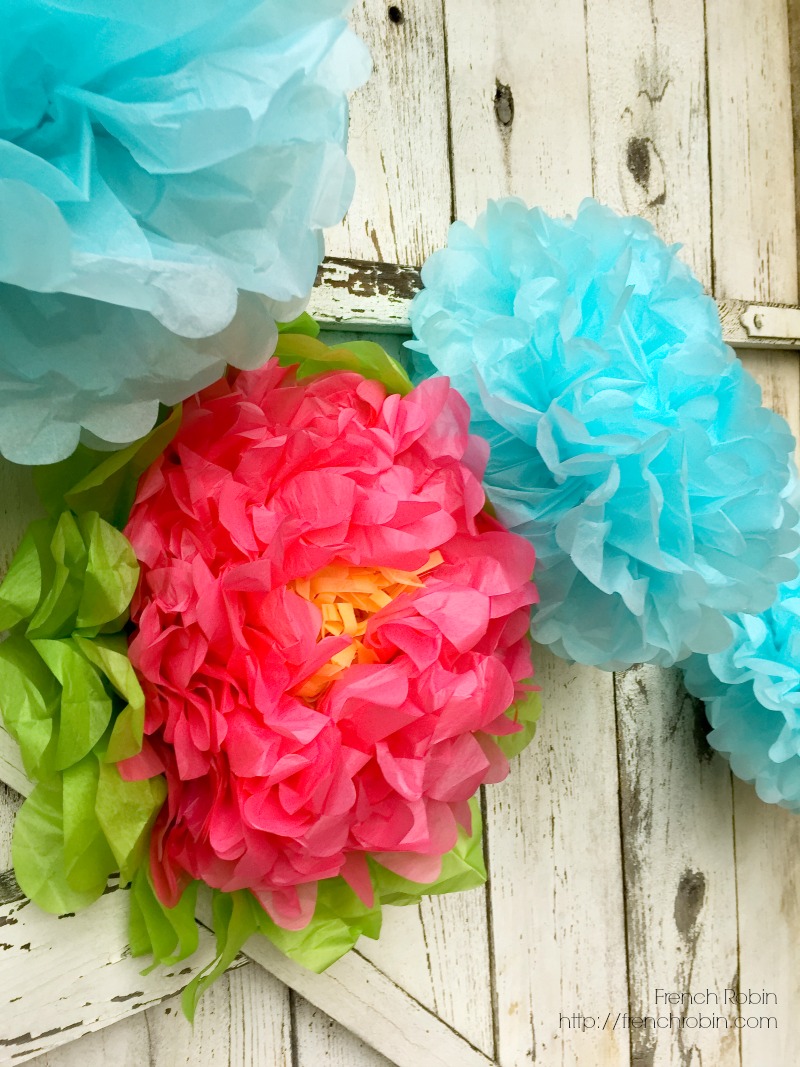Large tissue paper flowers provide fun texture and color in a photo backdrop. 