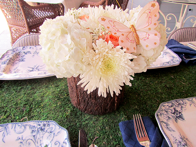 Bring the outdoors in by using a moss table runner and putting your flowers in a wooden vase. 
