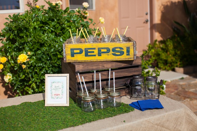 An old Pepsi crate makes a great cup holder for a backyard party drink table. 