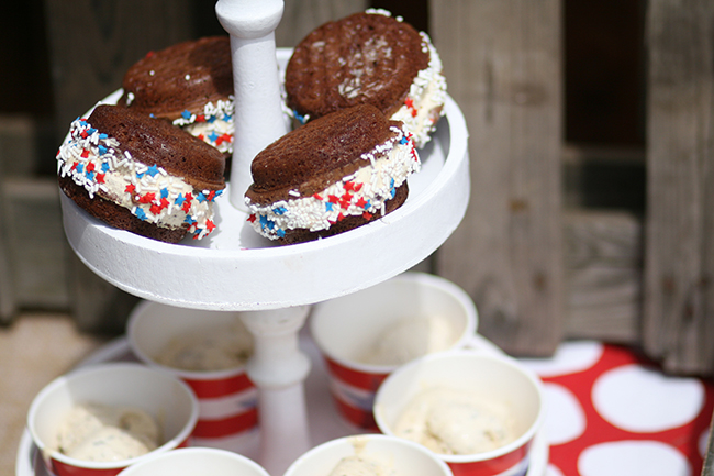 Thick ice cream sandwiches made with homemade cookies, and a touch of red and blue sprinkles on the edges. Perfect for a fourth of July party!