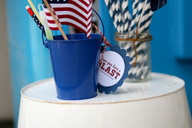 Add a few small treats or toys in a bucket as a gift for your younger guests. They will love it! | July 4th party ideas.