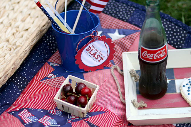 Coke in a glass bottle, cherries, and treat buckets with July 4th themed goodies. Great ideas for your next fourth of July party. 