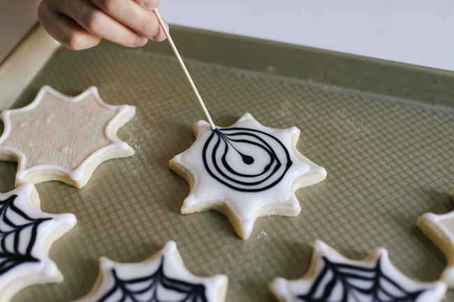 Use a toothpick to create the most awesome Spiderweb design for these delicious cookies.
