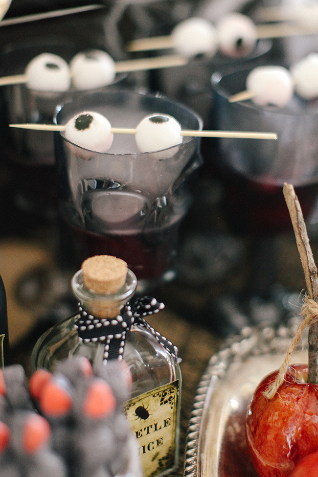 Gummy eyeballs and dry ice are the perfect addition to any spooky Halloween Punch. Especially if it is served at an Evil Queen Party like this one!