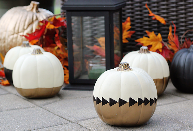 Black, white, and gold painted pumpkins