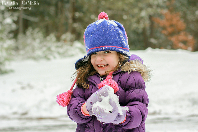 Little girl with snowball.