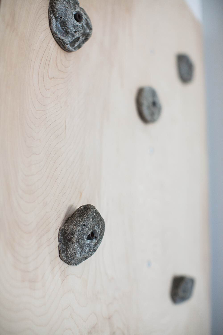 Screw your rock climbing holds into the board before you attach it to the wall.