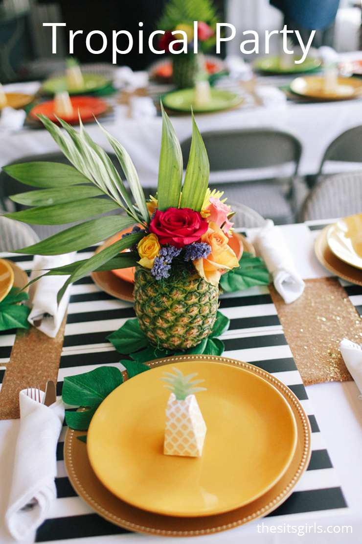 How to throw the perfect tropical party with delicious food and cute party decor. The flamingos and pineapple flower arrangements make it extra fun.