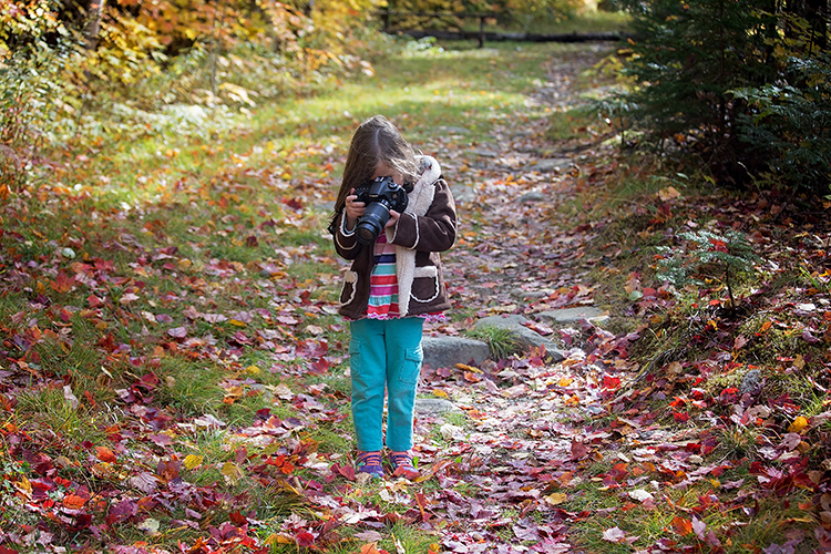 Girl Taking Photos Of Fall Leaves