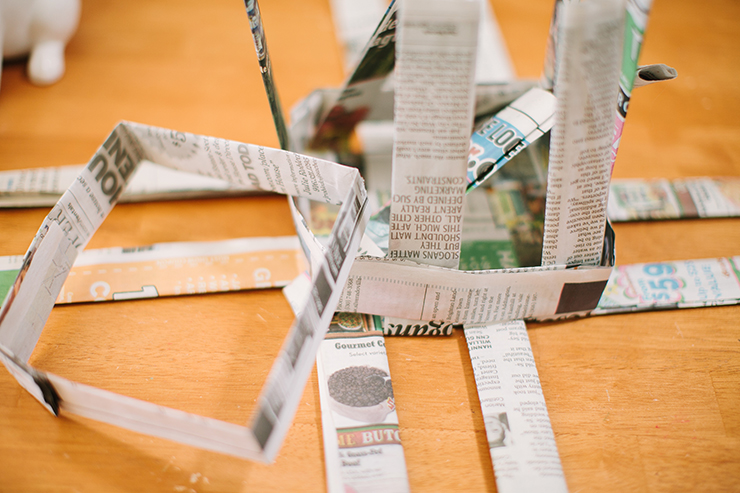 Form newspaper strips into a square to make your newspaper basket.