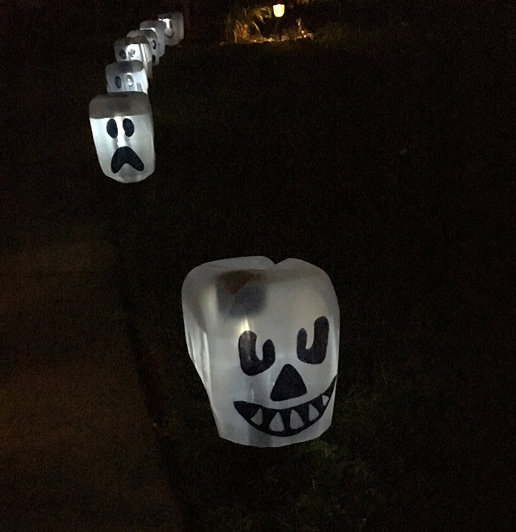 Use dollar tree stakes to make these glowing ghosts!