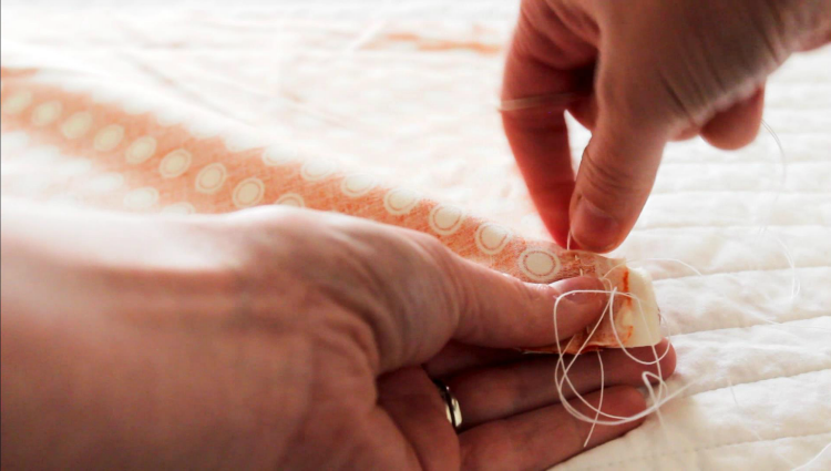 stitching fabric to make a pumpkin