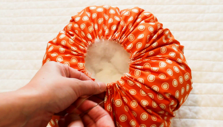 Gather your fabric around the stuffing to create a pumpkin