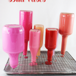 Painted glass bottle vases are a great DIY to brighten up any room with a pop of color.