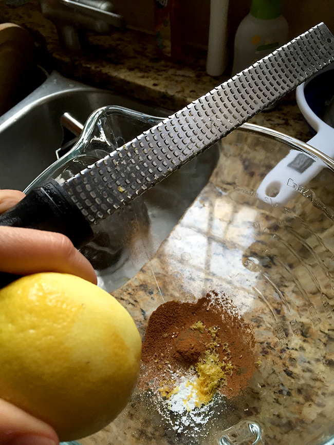 Zesting a lemon for zucchini bread.