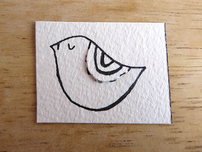 Cut a slit along the bird's wing to create your bookmark.