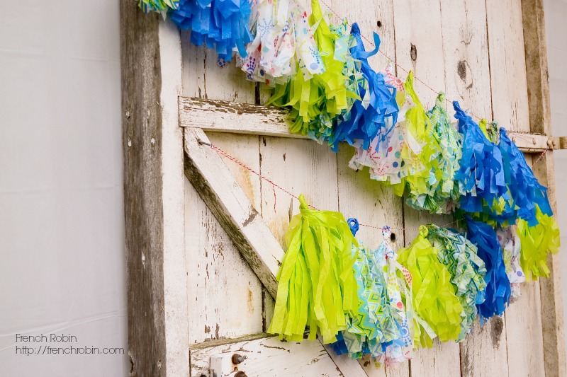 Tissue paper can be rolled and folded to make a cute tassel banner. Perfect for stringing on an old door or a solid background to make a fun DIY photo backdrop. 