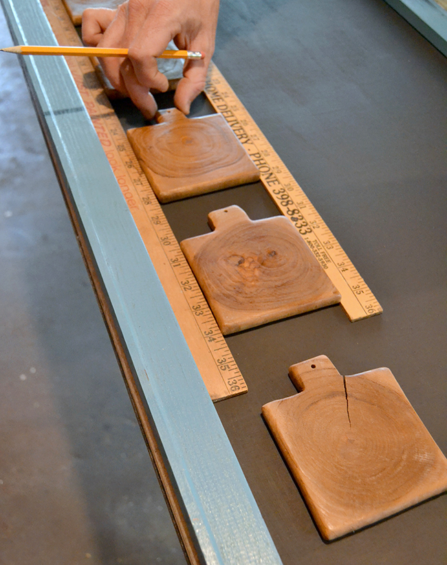Use rulers to space out the coasters or pieces of wood on your chalkboard.