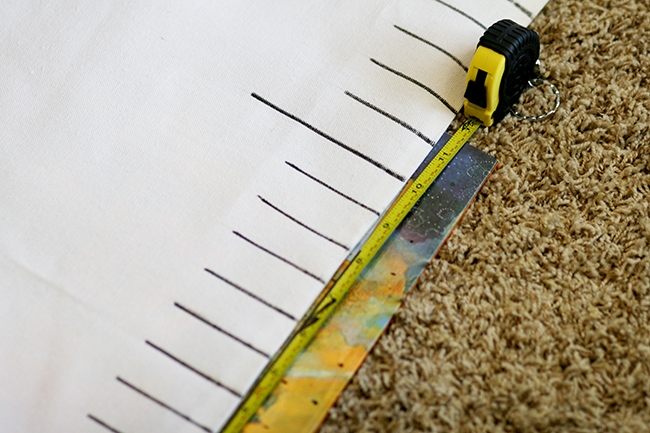 Use a tape measure to space out the lines evenly on your ruler table runner. 