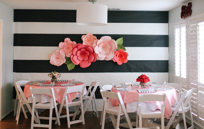 This is the most amazing accent wall we have ever seen! Huge paper flowers adorn bold stripes.