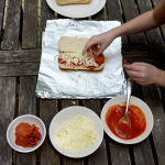 Everyone is going to love this delicious campfire pizza! You can easily make it on the grill, or with an actual campfire. Delicious, easy summer dinner idea.