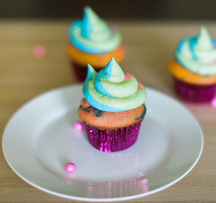 How to make Rainbow Cupcakes. This cupcake recipe includes the secret for getting the perfect rainbow swirled frosting on every cupcake.