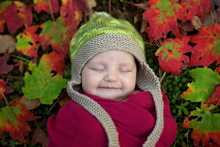 Baby in fall leaves
