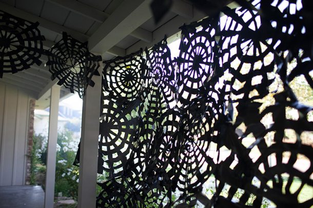 You can use trash bags to make amazing Halloween decor! Trash bag spider webs are a fun and easy project. Cover your porch in spooky spider webs with this easy tutorial (step by step instructions and video tutorial).