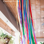 Ribbon chandeliers are super versatile and make great party decorations. Use any pattern or color of ribbons you like to make a dramatic statement piece.