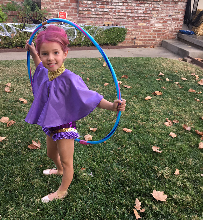 girl wearing halloween costume inspired by the greatest showman
