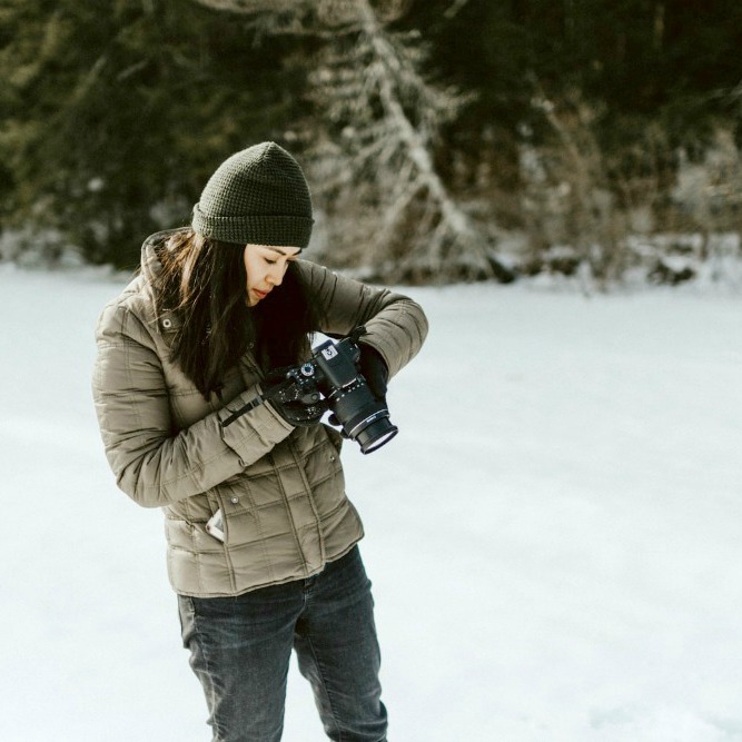 woman taking pictures in the snow