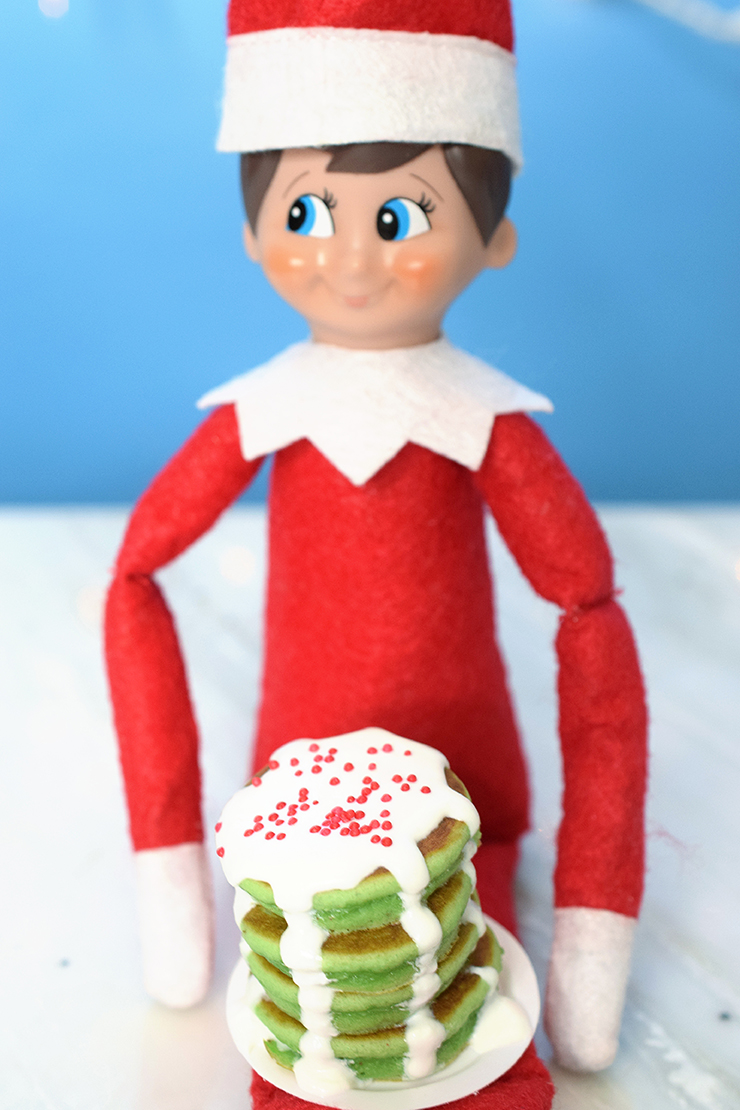 Elf holding mini pancakes wtih plate