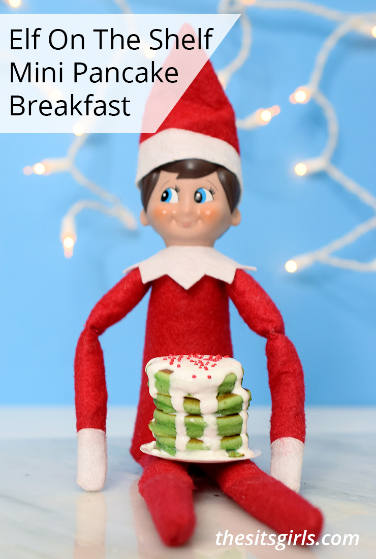 Elf on the Shelf mini pancake breakfast | Elf holding stack of green pancakes topped with icing and sprinkles