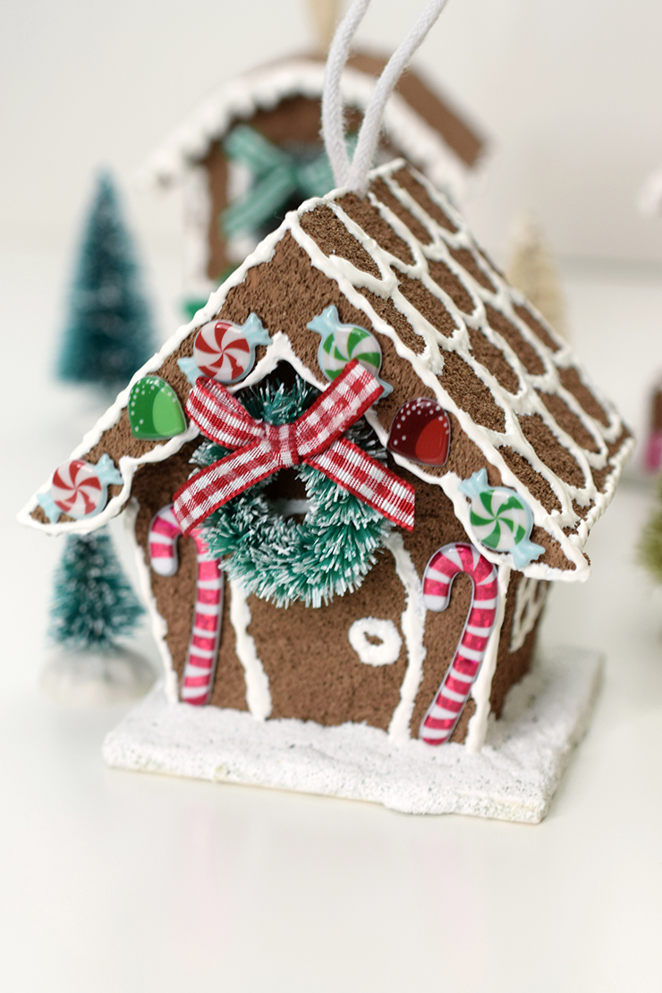 birdhouse, painted like a gingerbread house, with Christmas decorations and stickers to finish the look