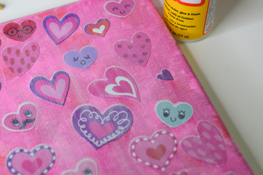 Mod Podge painted over stickers on canvas.