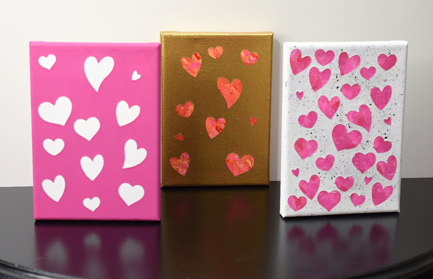 Three canvases with Valentine's Day artwork, each canvas has hearts.