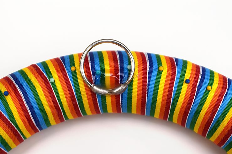 Hot glue a metal ring to the back of the wreath for hanging.