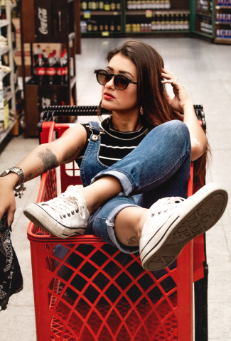 woman sitting in shopping cart