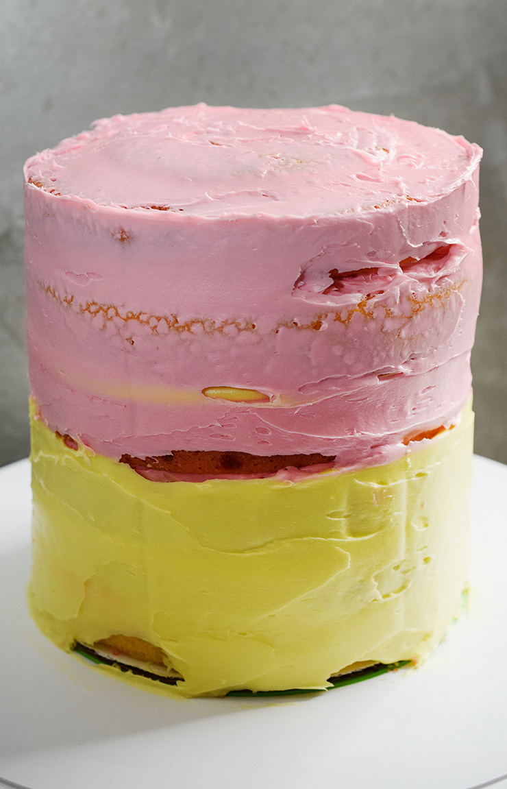 Layered cake with a crumb coat of frosting.
