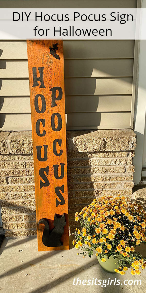 Orange sign with brown letters that spell HOCUS POCUS. 