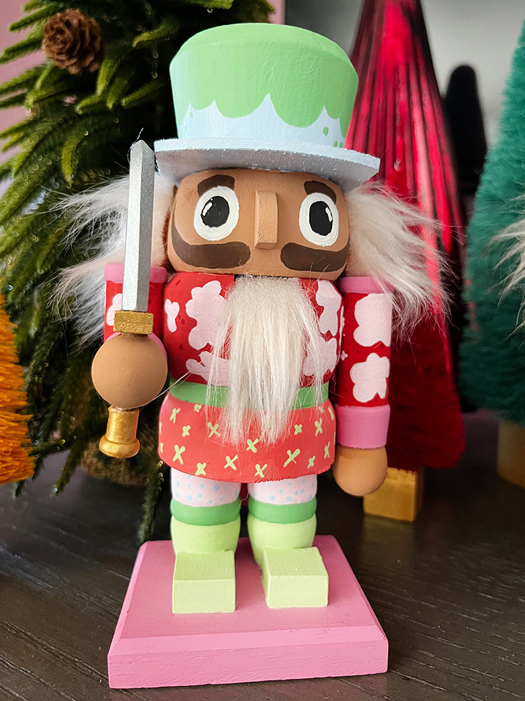 Nutcracker with a sword and a blue and green hat.