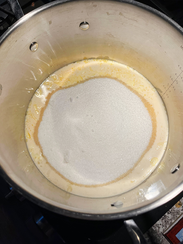 Saucepan with sugar, butter, adn evaporated milk.