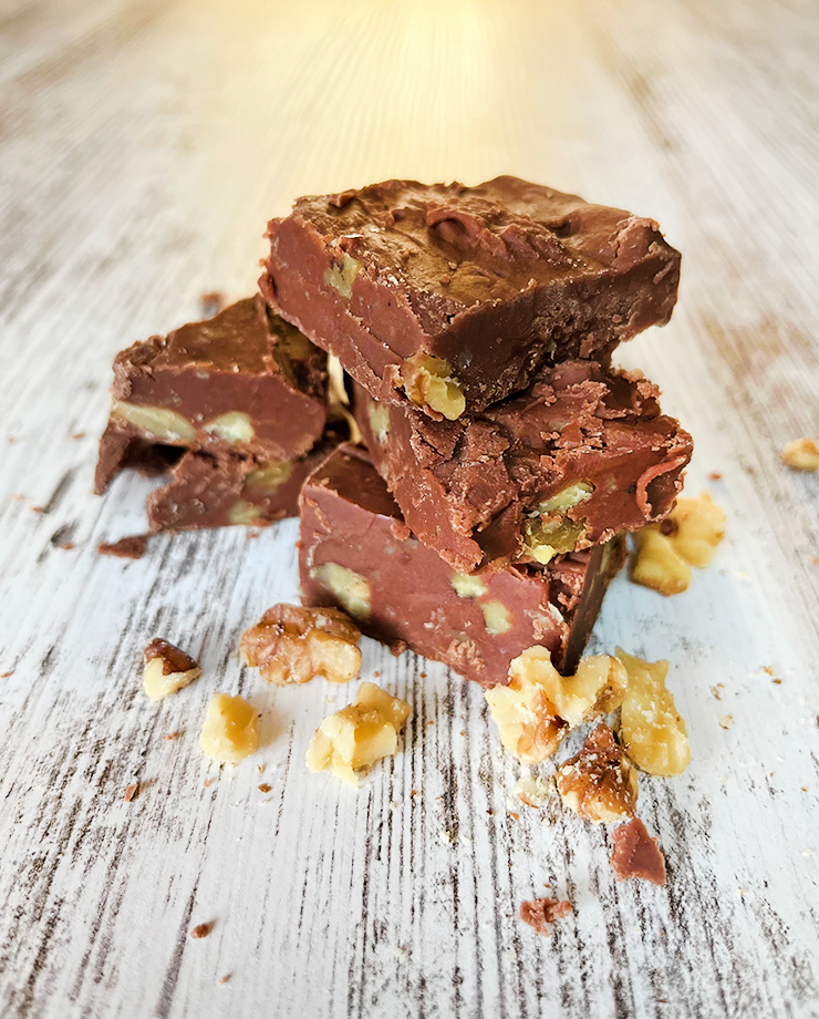 Stack of fudge on a board made with an easy fudge recipe.
