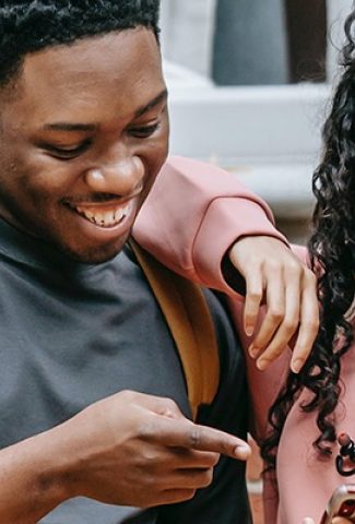 Two people looking at a phone.