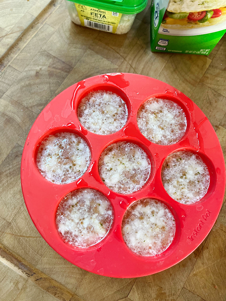 Silicone mold with egg bite ingredients mixed together and ready to be cooked in a pressure cooker.